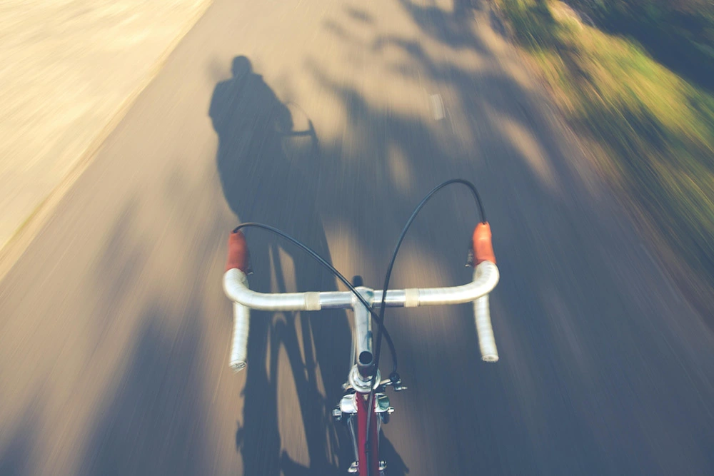 A picture of a person riding a bicycle from the riders pov.