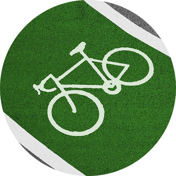 A circular photo of an outlined bike path on the side of a road.